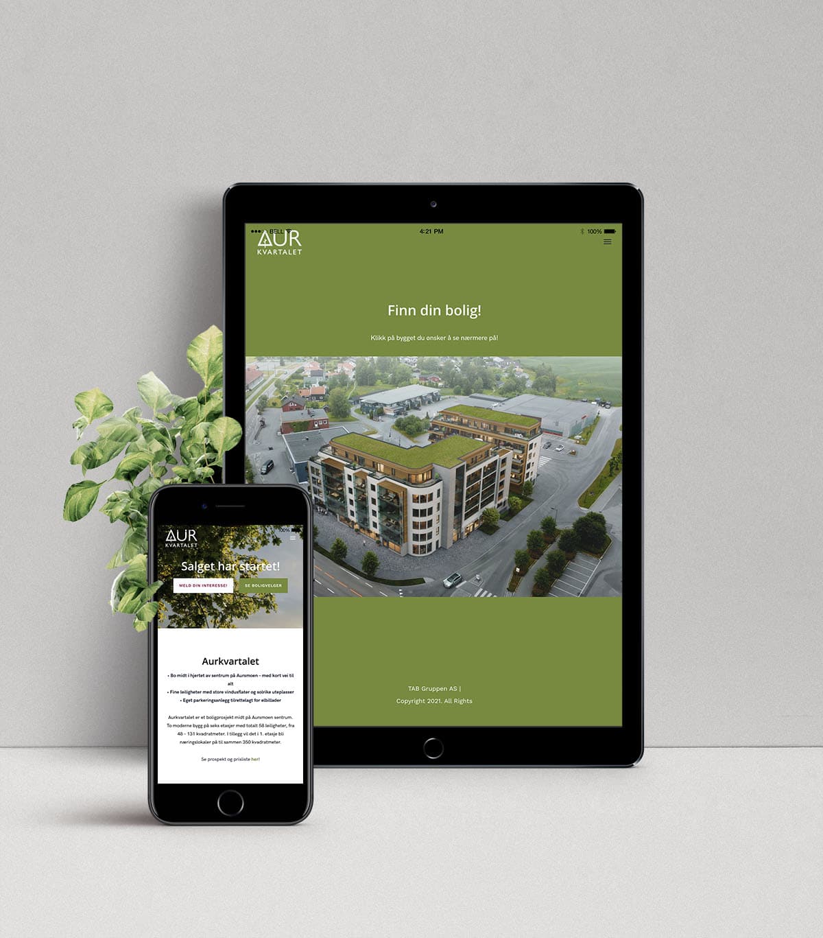 Mockup av websidene til Aurkvartalet, vist på mobil og skjermbrett